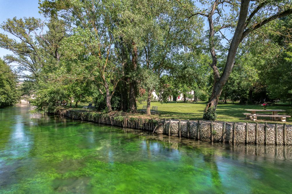 The clear green water of the Sorgue River along the property's frontage